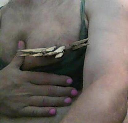 Crossdresser breast in clothespins