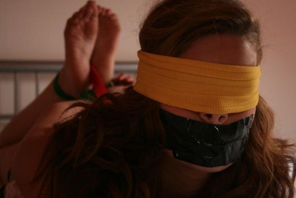 Girl gagged and blindfolded in bed